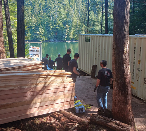 Remote Made Easy workers, preparing to unload a shipment of lumber.