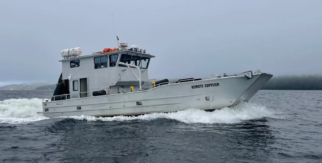 A Remote Made Easy boat in the ocean with a foggy shoreline in the distance.